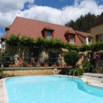 The Family Suite terrace at La Belle Demeure, Bed and Breakfast in the heart of the Périgord Noir, Dordogne near to Sarlat. Pleasantly furnished en-suite guestrooms with comfortable beds, covered with 100% cotton Seersucker linen. Family Suite. Table d'hôtes Evening Meal and Swimming Pool.